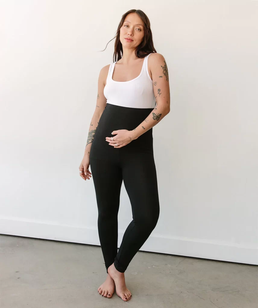 Pregnant woman wearing black maternity leggings
