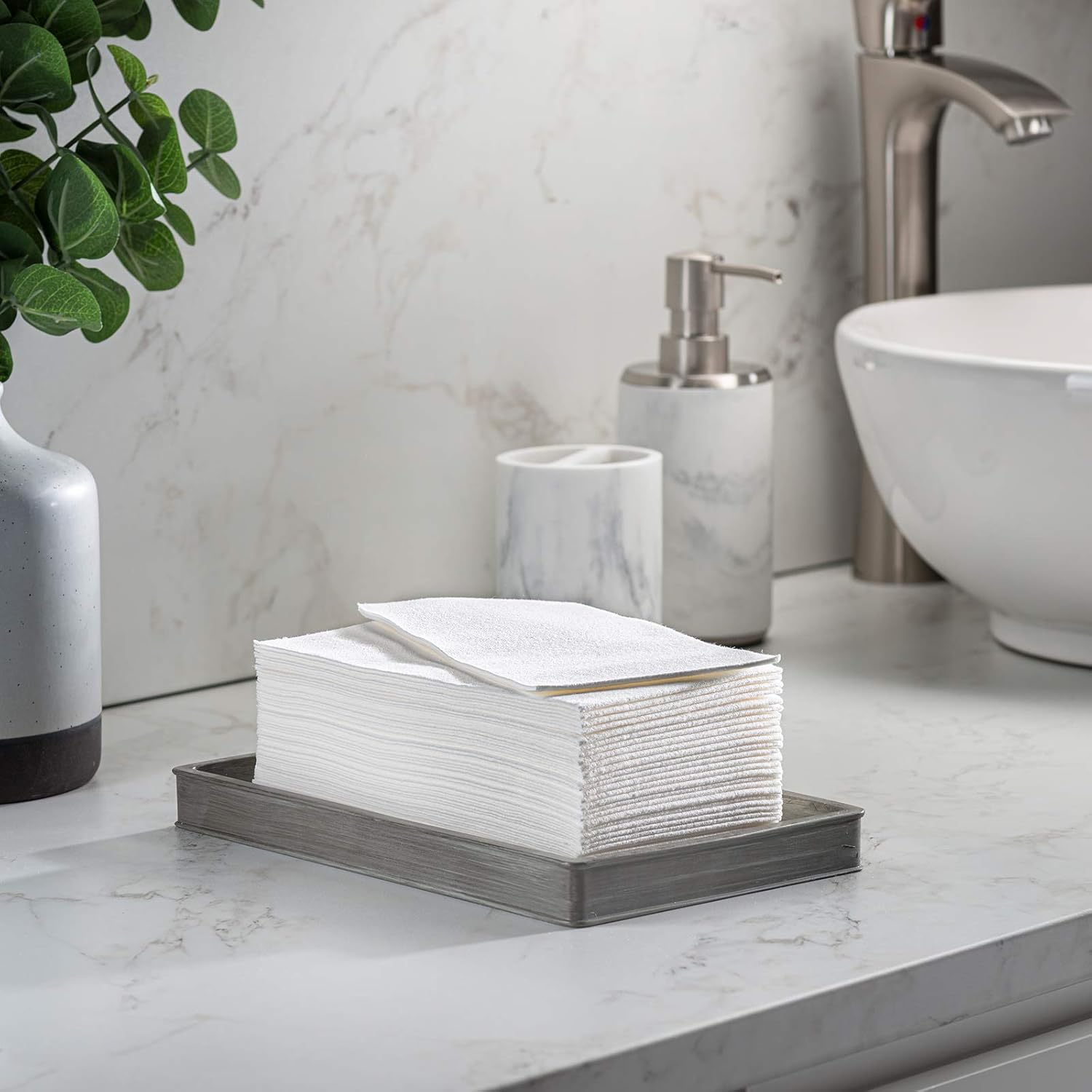 Disposable guest towels beside bathroom sink